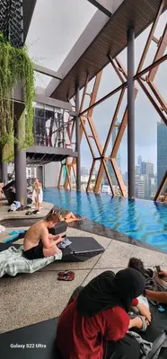 a group of people laying on the floor of a swimming pool at Scarletz Suite By Skyscraper in Kuala Lumpur