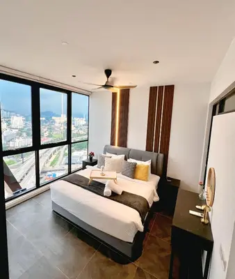a bedroom with a large bed and large windows at Scarletz Suite By Skyscraper in Kuala Lumpur