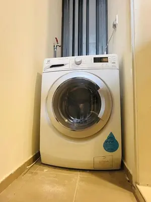 a washing machine sitting in the corner of a room at Robertson Special Suites By Luna in Kuala Lumpur