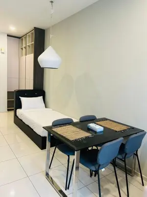 a bedroom with a bed and a table with chairs at Robertson Special Suites By Luna in Kuala Lumpur