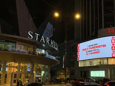 a city street at night with a sign for a store at Fahrenheit88 Opposite Pavilion KL Bukit Bintang in Kuala Lumpur