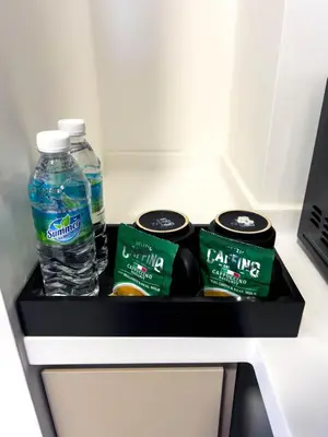 a refrigerator with two bottles of water and food at Premier Stay KL - Bangsar South - King Bed - Work Space - Near LRT, VE, Conexxion in Kuala Lumpur