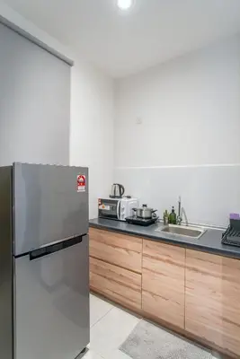 a kitchen with a stainless steel refrigerator and a sink at Neu Suites KL with Daily Breakfast Included in Kuala Lumpur