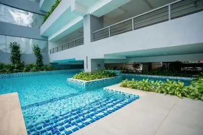 a swimming pool in the middle of a building at Neu Suites KL with Daily Breakfast Included in Kuala Lumpur