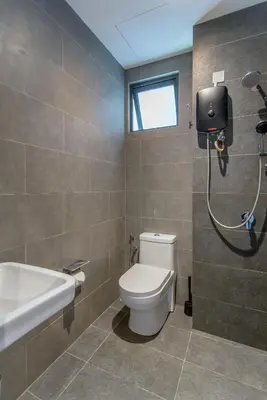 a bathroom with a toilet and a sink and a shower at Neu Suites KL with Daily Breakfast Included in Kuala Lumpur