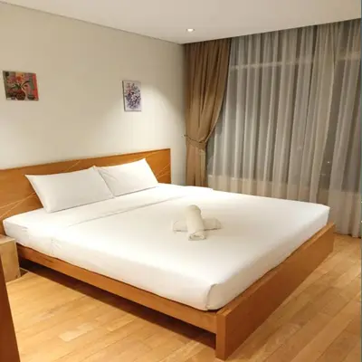 a bedroom with a white bed with a bow on it at Vortex klcc by Elham in Kuala Lumpur