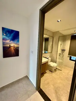 a bathroom with a toilet and a picture on the wall at Agile Bukit Bintang By Comfort Suites in Kuala Lumpur