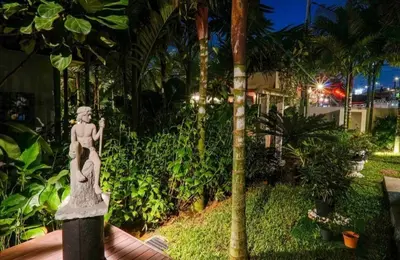 a statue of a woman on a pole in a garden at 68 Palms 04 l Midvalley l 6 Pax in Kuala Lumpur