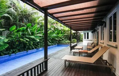 a patio with benches and a swimming pool at 68 Palms 04 l Midvalley l 6 Pax in Kuala Lumpur