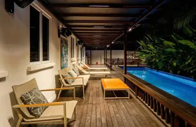 a swimming pool with lounge chairs and a table next to it at 68 Palms 04 l Midvalley l 6 Pax in Kuala Lumpur