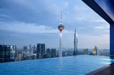 a infinity pool with a view of a city at Eastern Suites AT Platinum KLCC in Kuala Lumpur