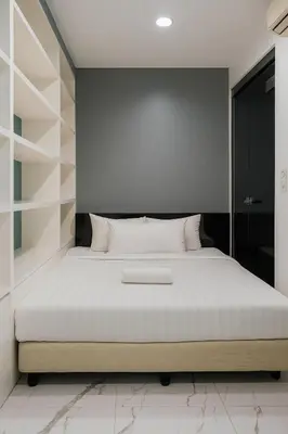 a bedroom with a large bed with white pillows at Eastern Suites AT Platinum KLCC in Kuala Lumpur