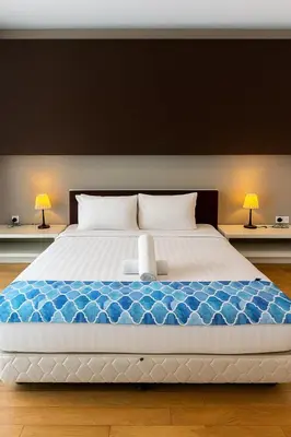 a large bed in a room with two lamps at Eastern Suites AT Platinum KLCC in Kuala Lumpur