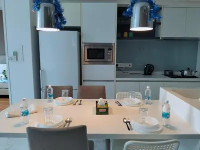 a white table with chairs and bottles of water on it at Eastern Suites AT Platinum KLCC in Kuala Lumpur