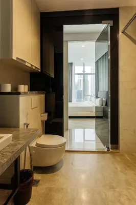 a bathroom with a toilet and a sink and a bedroom at Eastern Suites AT Platinum KLCC in Kuala Lumpur