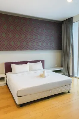 a large white bed with a teddy bear sitting on it at Eastern Suites AT Platinum KLCC in Kuala Lumpur
