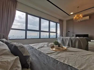 a bedroom with a bed with a tray with a plant on it at Arte Plus Ampang Studio near KLCC - Living Signature in Kuala Lumpur