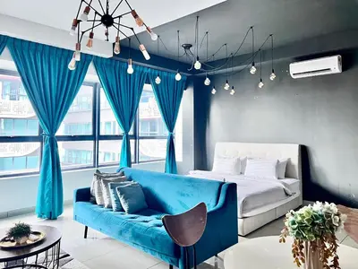 a bedroom with a blue couch and a bed at Arte Plus Ampang Studio near KLCC - Living Signature in Kuala Lumpur