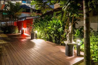 a wooden walkway with a statue of a woman on it at 68 Palms 03 l Midvalley l KL Sentral in Kuala Lumpur