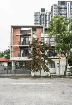 a brick building with a tree in front of it at 68 Palms 03 l Midvalley l KL Sentral in Kuala Lumpur