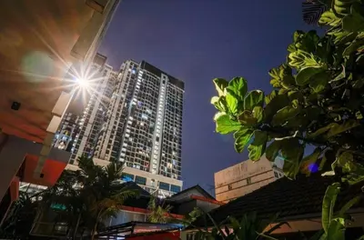 a building with the sun shining on it at night at 68 Palms 03 l Midvalley l KL Sentral in Kuala Lumpur