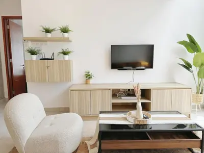 a living room with a tv and a chair and a table at 68 Palms 03 l Midvalley l KL Sentral in Kuala Lumpur