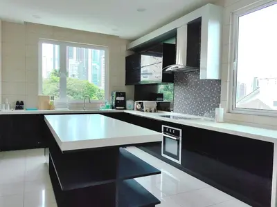 a kitchen with black and white counters and a large window at A3A l Near KLCC TRX l Santorini l 18 Guests in Kuala Lumpur