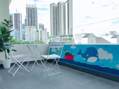 a balcony with two chairs and a painting of a whale at A3A l Near KLCC TRX l Santorini l 18 Guests in Kuala Lumpur