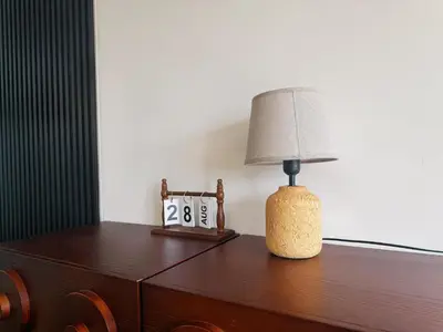 a lamp sitting on top of a table with a clock at Cozy Studio l Riveria City l 1km to KL Sentral in Kuala Lumpur