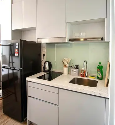a kitchen with a black refrigerator and a sink at Cozy Studio l Riveria City l 1km to KL Sentral in Kuala Lumpur