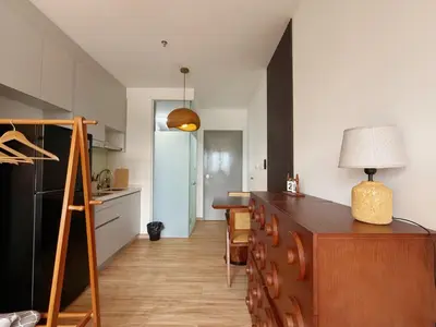 a kitchen with a counter and a dining room at Cozy Studio l Riveria City l 1km to KL Sentral in Kuala Lumpur
