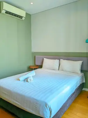 a bedroom with a large bed with blue sheets at Sky Suites KLCC Kuala Lumpur LB in Kuala Lumpur