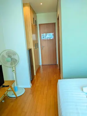 a bedroom with a bed and a desk with a fan at Sky Suites KLCC Kuala Lumpur LB in Kuala Lumpur
