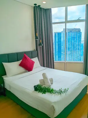 a bedroom with a large bed with a window at Sky Suites KLCC Kuala Lumpur LB in Kuala Lumpur