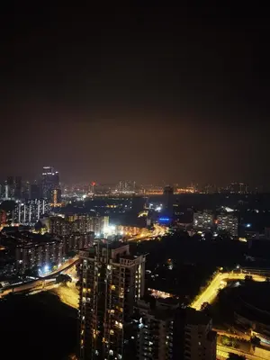 a view of a city at night with lights at The Roberstson family suite with city views in Kuala Lumpur