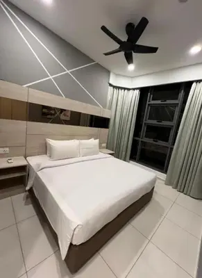 a bedroom with a bed with a ceiling fan at The Roberstson family suite with city views in Kuala Lumpur