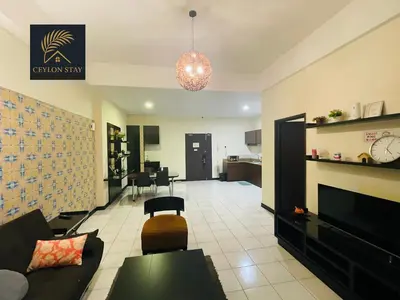 a living room with a couch and a fireplace at Ceylon Stay in Kuala Lumpur