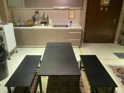 two benches in a kitchen with a table at Infinity Sky pool hostel best in Kuala Lumpur
