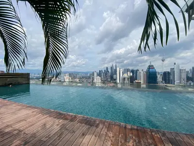 a swimming pool on top of a city skyline at CloudNest Infinity Sky pool Hostel in Kuala Lumpur
