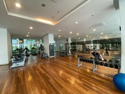 a gym with a hard wood floor and people exercising at CloudNest Infinity Sky pool Hostel in Kuala Lumpur