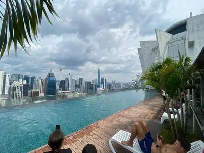 a swimming pool on the roof of a building with a city at Skyfloat Infinity Hostel in Kuala Lumpur