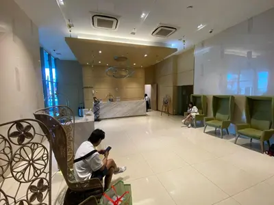 a man sitting on a chair in a room at Skyfloat Infinity Hostel in Kuala Lumpur
