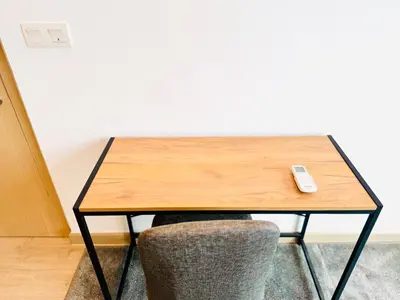 a table with a remote control sitting on top of it at The Luxe & Colony KLCC By Comfort Dwellings in Kuala Lumpur