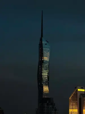 a tall building is lit up at night at The Luxe & Colony KLCC By Comfort Dwellings in Kuala Lumpur