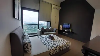 a bedroom with a bed and a couch and a window at KL Sentral, EST Bangsar#12, LRT in Kuala Lumpur