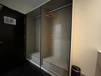 a walkin closet with glass doors in a room at Kingston Hotel by Minsu in Kuala Lumpur