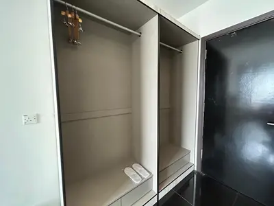a walk in closet with two white shoes in it at Kingston Hotel by Minsu in Kuala Lumpur
