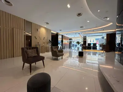 a lobby with two chairs and a table in a building at Kingston Hotel by Minsu in Kuala Lumpur