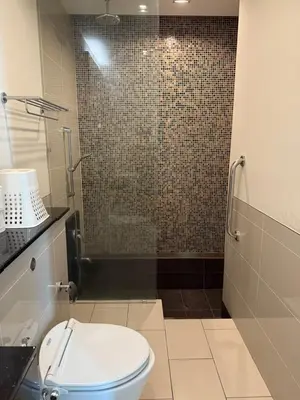 a bathroom with a toilet and a shower at Swiss Garden Residences by Roomy in Kuala Lumpur