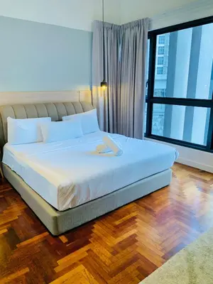 a bedroom with a white bed with a large window at The Mews Suites KLCC By Luna in Kuala Lumpur